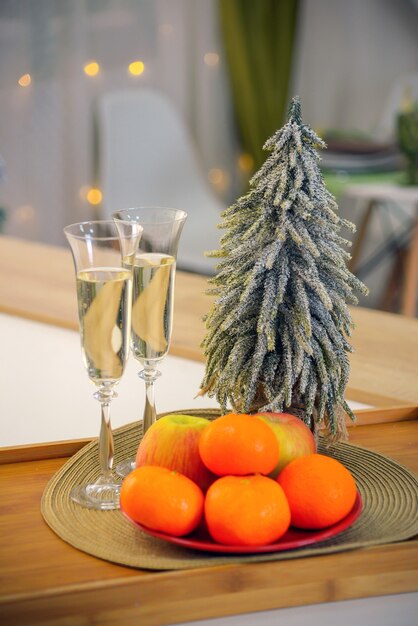 festive champagne in glasses for christmas on the background of a christmas tree