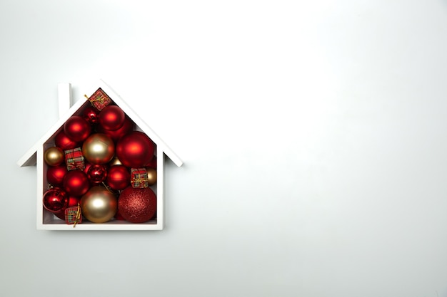 Festive Christmas composition with house and with Christmas balls. top view