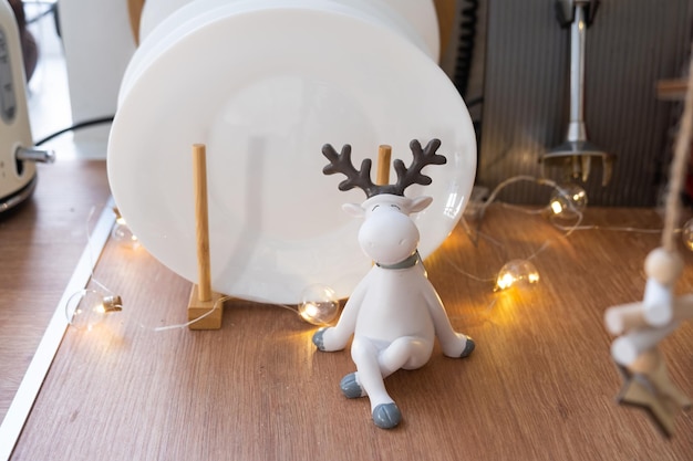 Festive Christmas decor and mess in the kitchen stand with plates cute deer New Year mood home interior close up