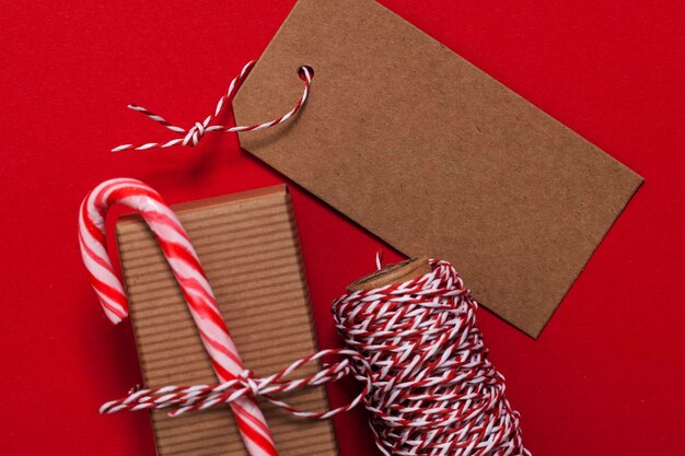 Festive Christmas present with candy cane on a red background