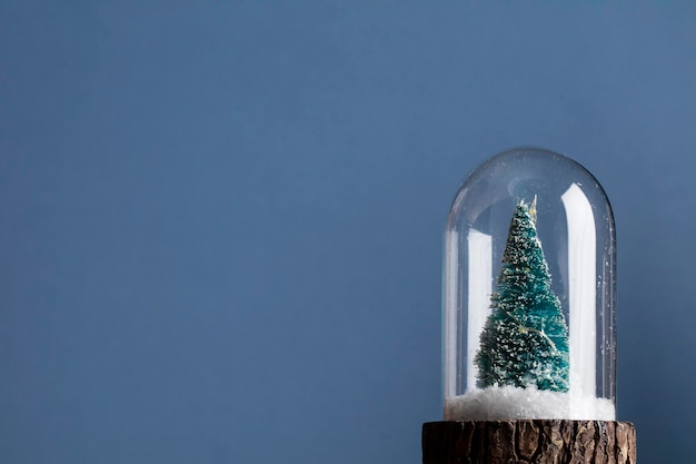 Festive christmas scene Christmas tree inside a glass snowglobe