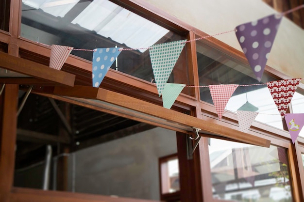 Festive colorful flags decorated on wooden architecture