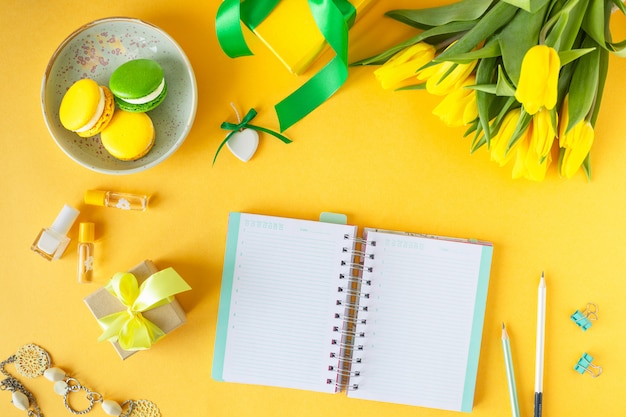 Festive composition: boxes with gifts, ribbons, flowers, jewelry and paper notebook, Top view with copy space