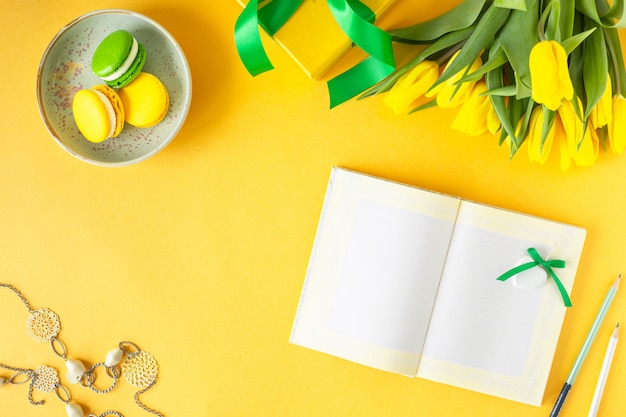 Festive composition: boxes with gifts, ribbons, flowers, jewelry and paper notebook, Top view with copy space