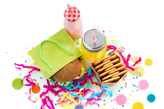 Photo festive composition drinks snacks holiday hamburger cookie tinsel confetti gift box