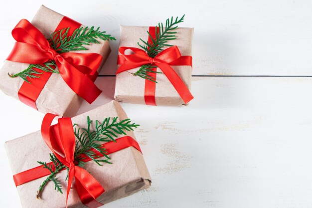 Festive composition. Gift boxes with red ribbon and Christmas balls on a white background.