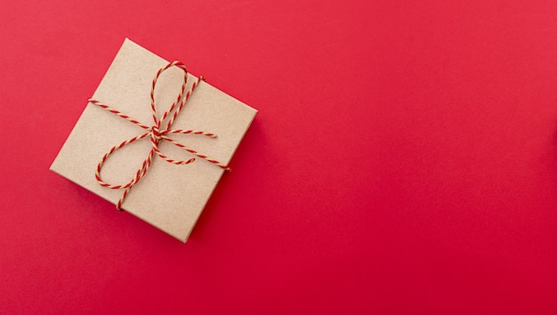 Festive composition with gift box. Paper box with ribbon, top view