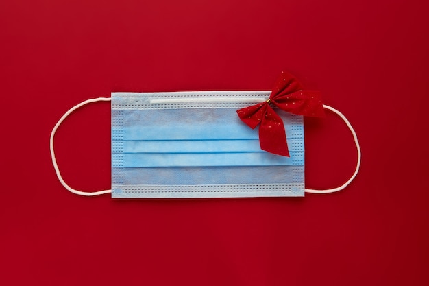 Festive coronavirus face mask with decorations on red