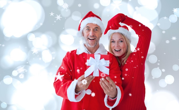 Festive couple against white glowing dots on grey