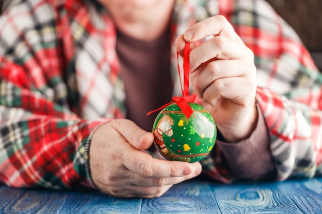 Festive cristmas decoration ball in male hand