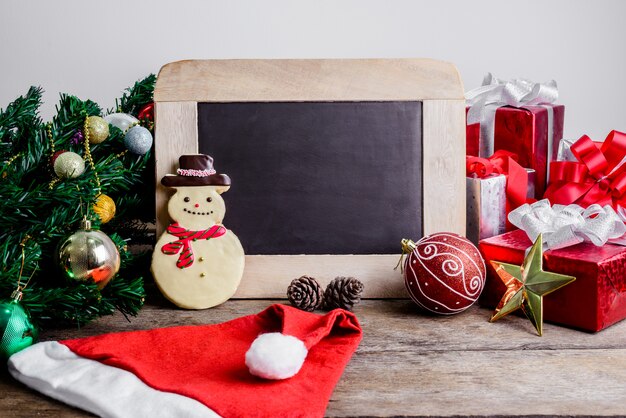 Festive Decoration, Christmas Cookie and New Year in the shape of snowman on wooden table