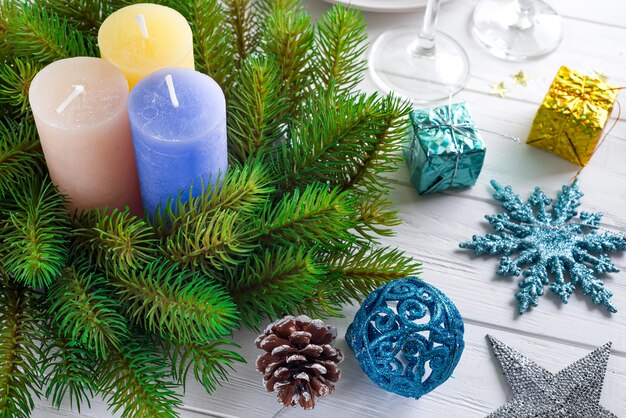 Festive decoration on Christmas table setting with candles, lantern, tableware 