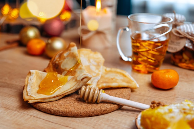 Photo festive dessert table homemade cakes, pancakes with honey, desserts with honey