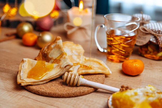 Photo festive dessert table homemade cakes, pancakes with honey, desserts with honey