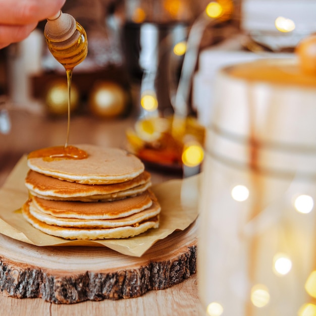 festive dessert table homemade cakes, pancakes with honey, pour honey on pancakes