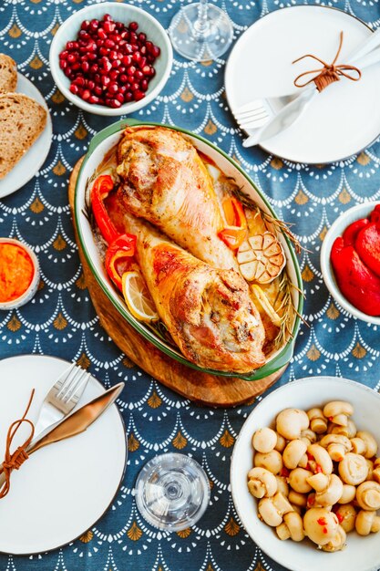 Festive dish for Thanksgiving roasted turkey legs with vegetables on a table with snacks Top view flat lay