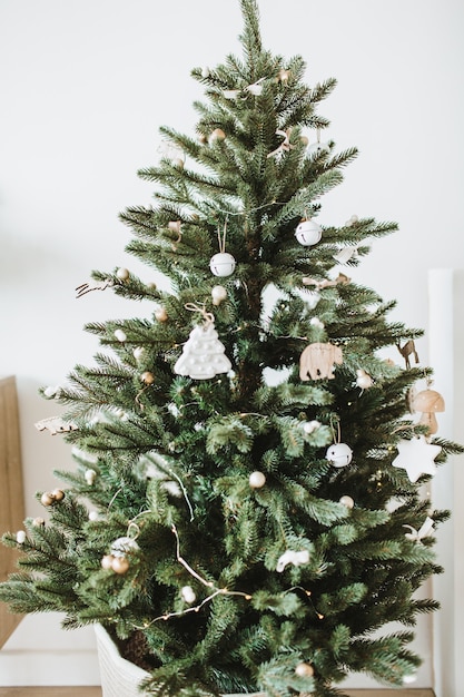 Photo festive fir-tree decorated with toys, gifts, balls