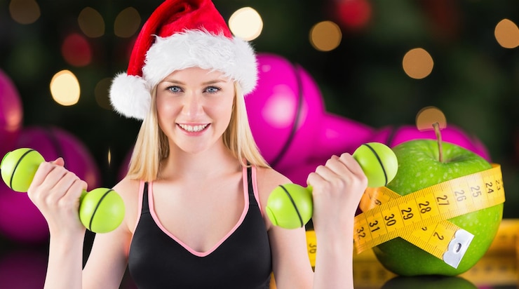 Photo festive fit blonde smiling at camera against measuring tape