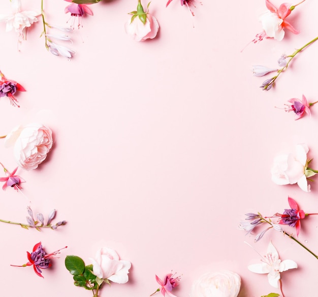 Festive flower composition on the pink background Overhead view