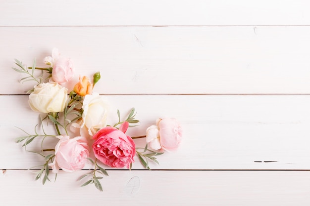 Festive flower composition on the white wooden background Overhead view