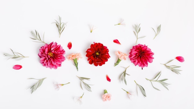 Festive flower composition on the white wooden background overhead view