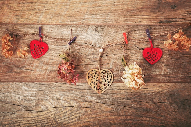 Photo festive flowers composition frame made of dried flowers hydrangea handmade crocheted red hearts