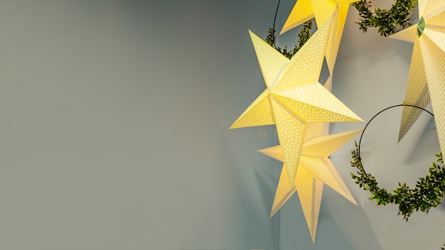 festive garland in the form of golden star with wreaths for Christmas, New Year on grey background.