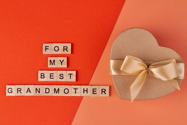 Festive gift box and wooden blocks with inscription For my best grandmother