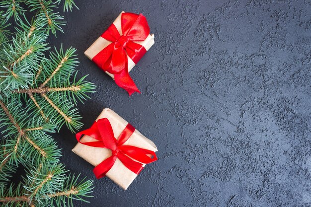 Festive gift boxes with spruce branches on concrete background. The concept of New Year and Christmas. Flatlay. Copyspace. Postcard