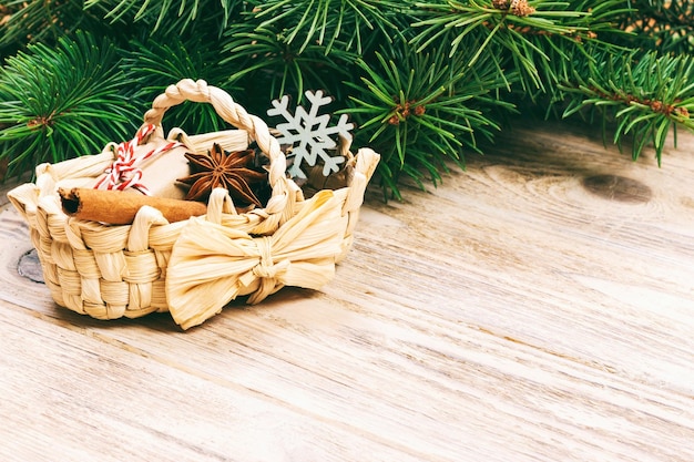 Festive Gifts with boxes star anice basket cinnamon and snowflake on Wooden Background Christmas Presents with copy space Toned