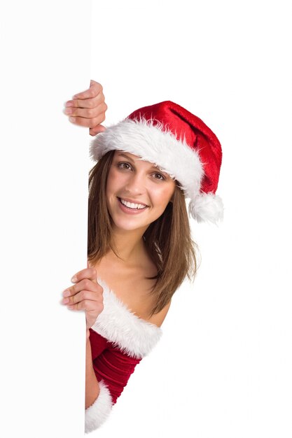 Festive girl smiling at camera holding poster