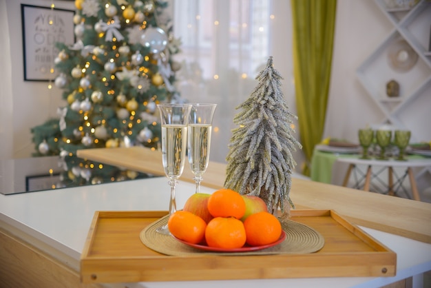 festive glasses with champagne on the background of a Christmas tree in Christmas