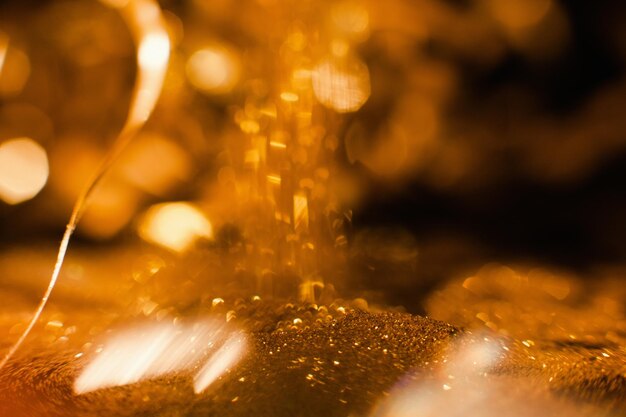 Festive gold glitter background Blur bokeh lights New year holidays celebration Joy and happiness concept