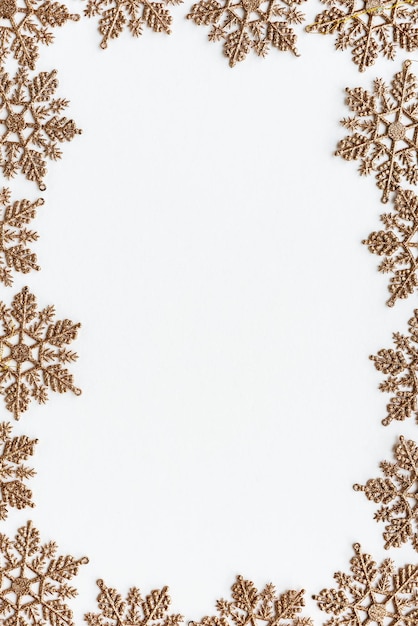 Festive golden snowflakes frame design