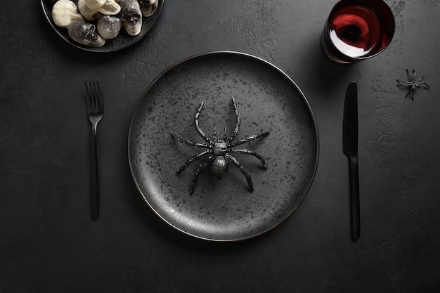 Festive Halloween table setting with spider and black decor