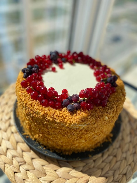 Festive honey cake decorated with live berries and crumbs