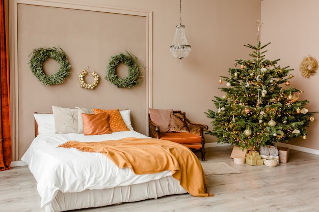 Festive interior bedroom in scandinavian style with wreath spruce branches gold toys