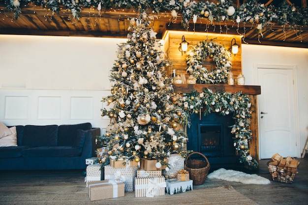 Festive interior: Christmas tree and fireplace gifts. The concept of Christmas and New Year.