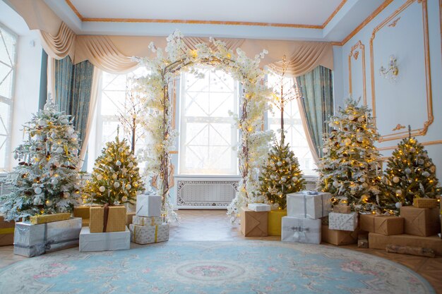 Festive interior: christmas tree and sofa with pillows, gifts. The concept of Christmas and the New year.