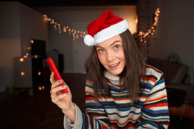 Festive lady holding smartphone