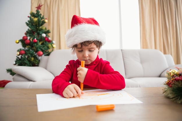 Festive little boy writing wish list