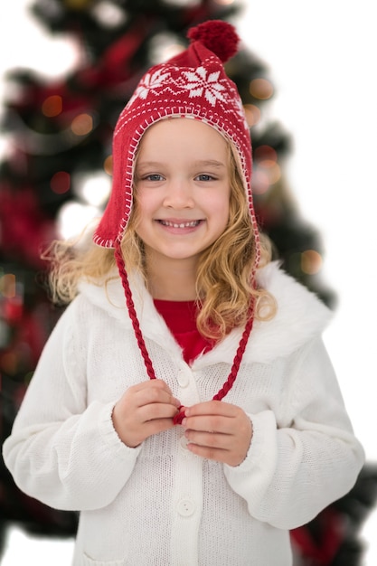 Festive little girl in hat and scarf