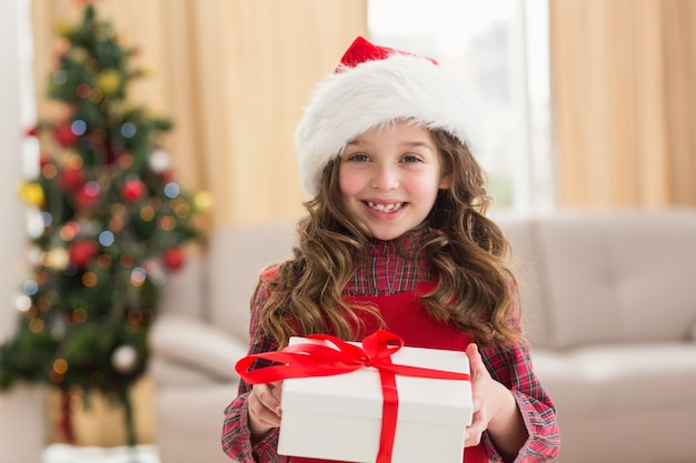 Festive little girl opening a gift