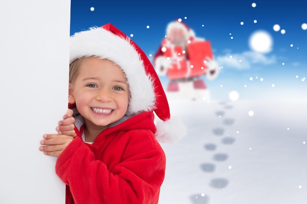 Festive little girl showing poster against bright blue sky over clouds