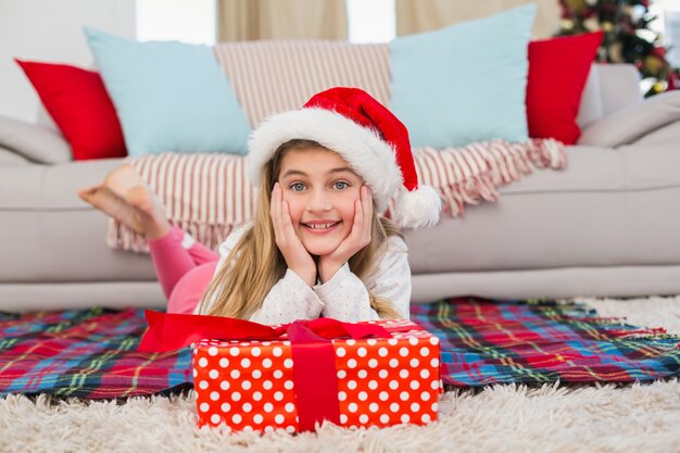 Festive little girl smiling at camera with gift