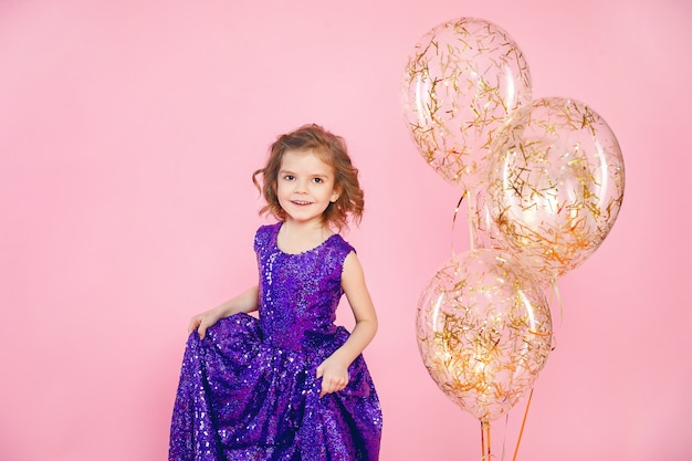 Festive little girl with balloons