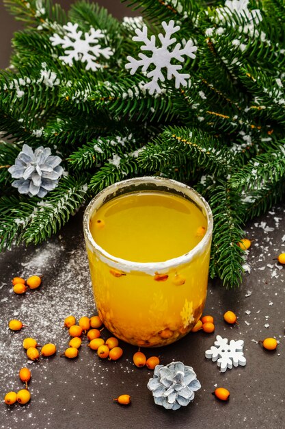 Festive low alcoholic fruit cocktail with fresh sea buckthorn berries