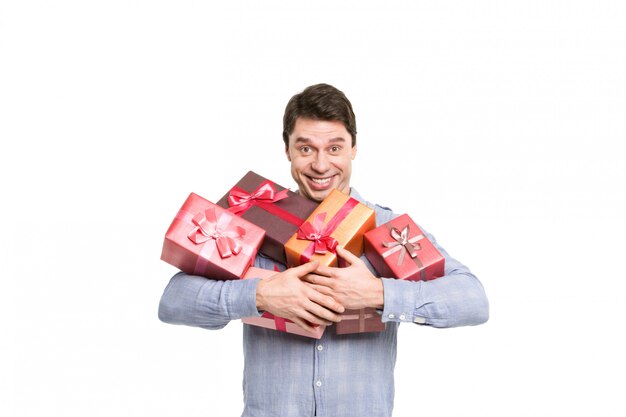 Festive man holding gifts on white.