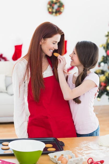 Festive mother and daughter baking together