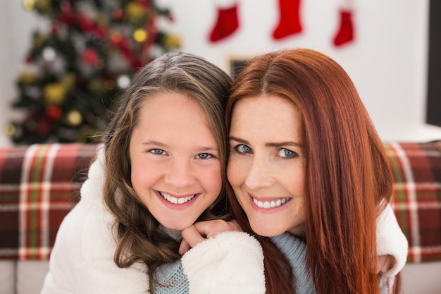 Festive mother and daughter on the couch